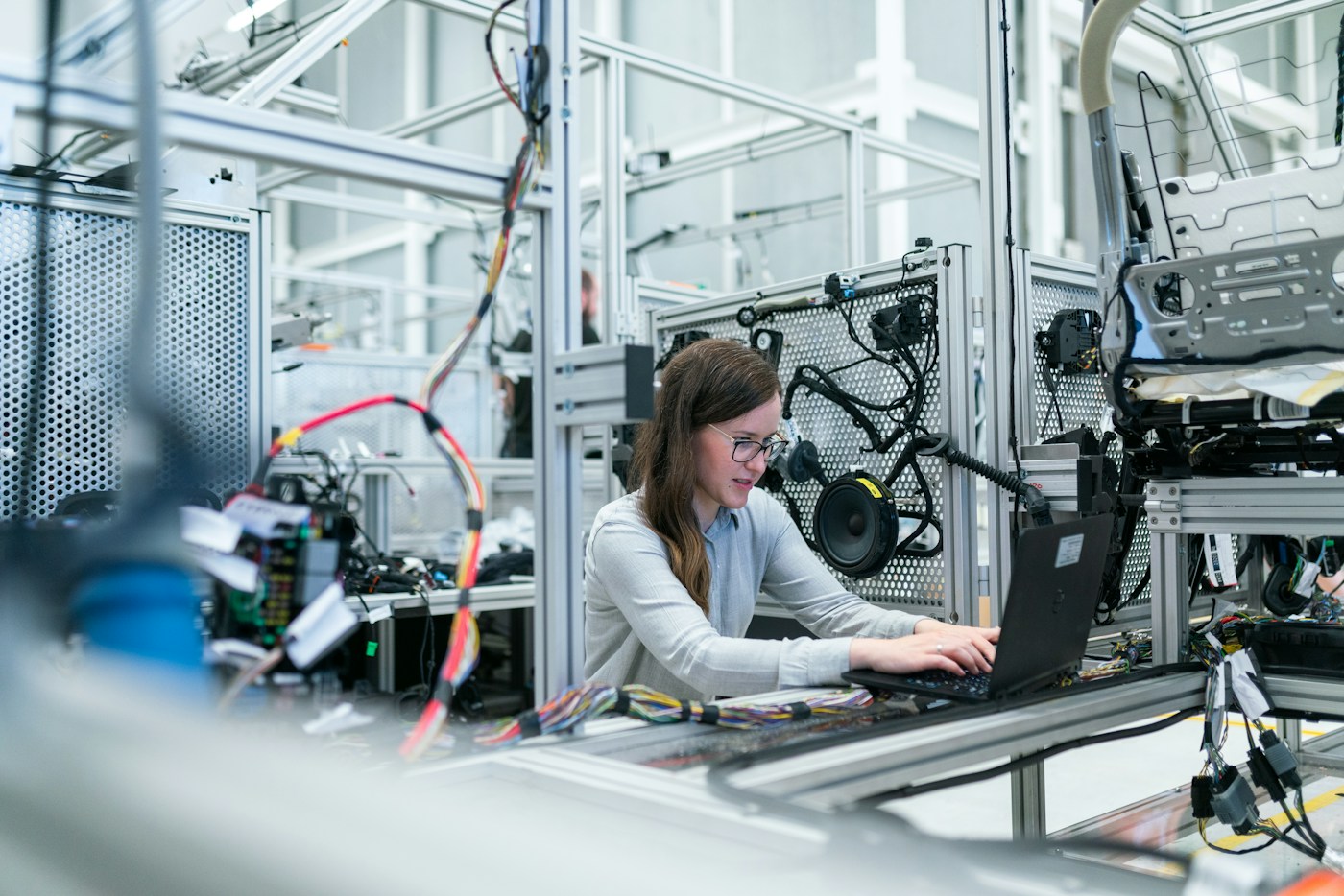 Engineer working beside industrial machinery